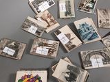 many old postcards on a table with a bunch of them