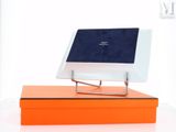 a laptop computer sitting on top of an orange box