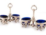 three silver and blue glass cups sitting on top of each other