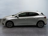 the silver car is parked on the concrete floor in the room