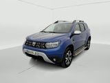 a blue dacia is parked in a white room