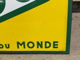 a yellow and green sign on the side of a building