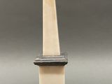 a white pedestal with a wooden base and a ball on top of it