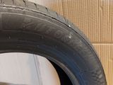 a close up of a tire on a wooden floor in front of a wall
