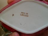 une personne tenant une assiette rouge et blanche à la main