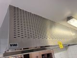 a stainless steel exhaust hood in a commercial kitchen