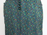 the skirt is green and blue with a small pattern on it