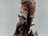 a statue of a boy with a dog on a pedestal