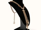 necklace on a mannequin stand with a gold chain on it