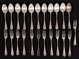 a lot of silver spoons and forks on a black background