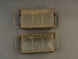 pair of antique brass metal trays with handles on a table