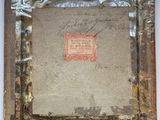 an old picture frame with a piece of paper taped around it
