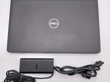 a dell laptop with a charger attached to it