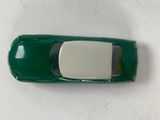 a green toy car with a mirror on top of it