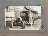 an old photo of a woman standing next to a car