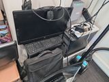 a black laptop computer sitting on top of a black chair