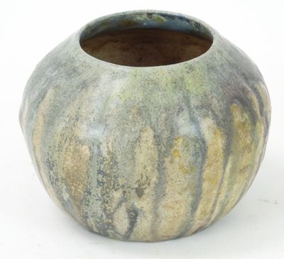 a vase that is sitting on a white surface
