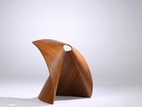 une image représentant une sculpture en bois posée sur une surface blanche