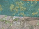 a close up of a piece of fabric with trees on it