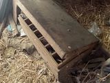 an image of a barn filled with hay and a wooden crate