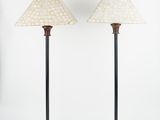 a pair of lamps on wooden bases with a white shade