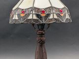 a close up of a lamp on a table with a black background