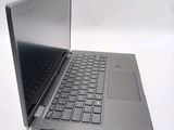 a silver laptop with a black keyboard on a white surface