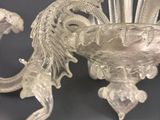 a glass vase with a dragon on top of it