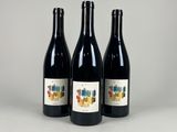 three bottles of wine sitting next to each other on a table