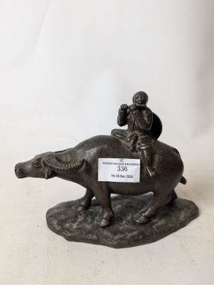figurine of a man riding a horse with a dog on its back
