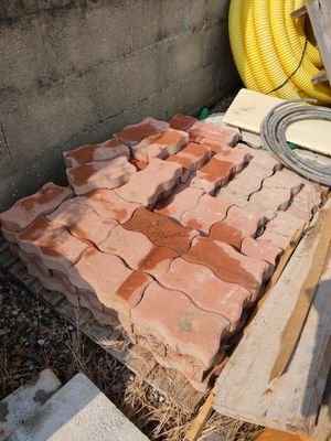 a pile of bricks sitting on the ground next to a pile of other bricks