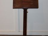a small wooden sign on a stand in a room
