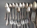 a lot of silver spoons and forks on the table