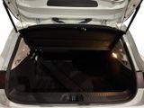 the trunk of a white car with its open doors open