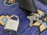 a keychain with a padlock and a key on a table