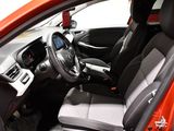 the interior of a red car with a steering wheel and dashboard