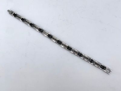 a silver and black pen sitting on top of a white table