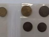 three different types of coins in plastic bags on a white surface
