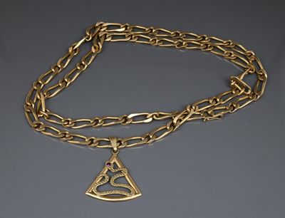 a close up of a gold chain with a triangle pendant on it
