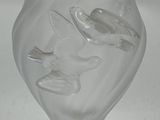 a clear glass vase with a bird design on it