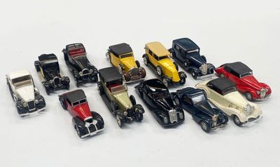 several toy cars are lined up in a row on a white surface