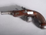 an old gun that is on display on a table