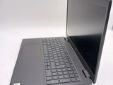 a laptop computer sitting on a table with a keyboard