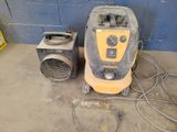 a yellow and black machine sitting next to a blue wall