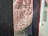 a hand that is holding a ticket in front of a door