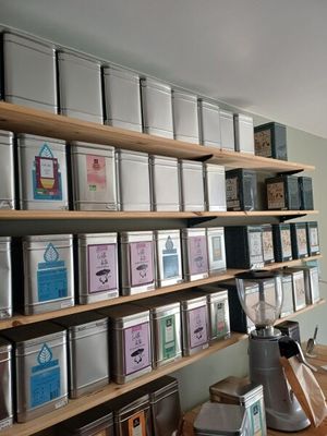 many tins of tea on the shelves in the room