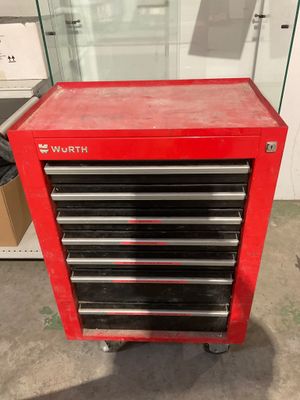 a red tool cabinet with five drawers on top of it