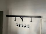 a picture of a room with a bunch of hooks on the wall