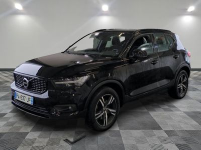 the black suv is parked on a checkered floor in a garage
