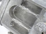 a metal object that is sitting on a white surface